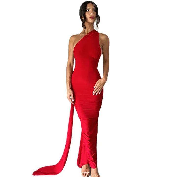 Woman wearing elegant red one-shoulder evening gown with long train and white high heels