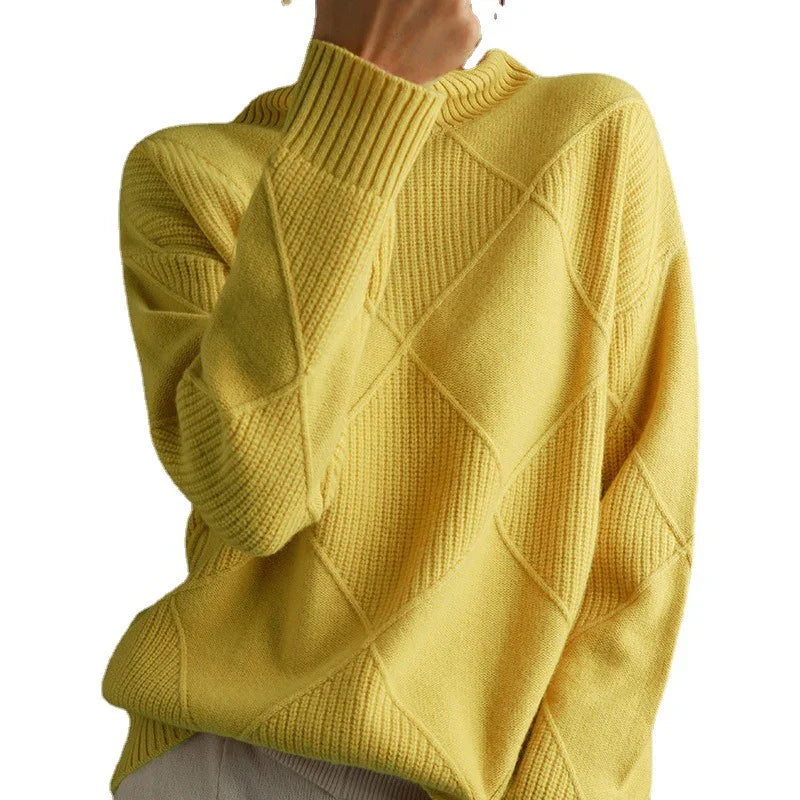 Close-up of person wearing a yellow textured knit sweater with geometric pattern