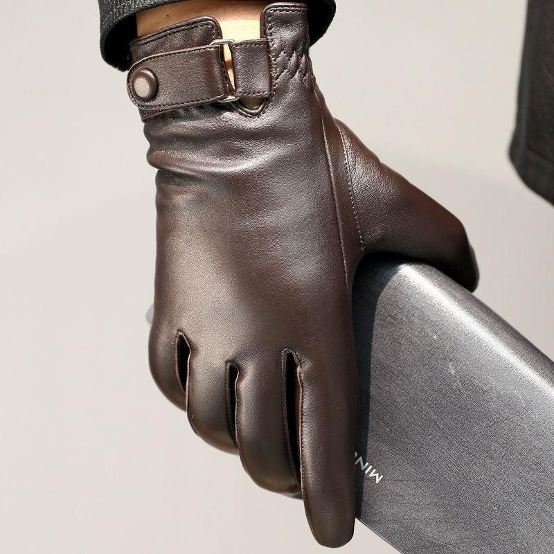 Close-up of a hand wearing dark brown leather gloves holding a sleek black wallet