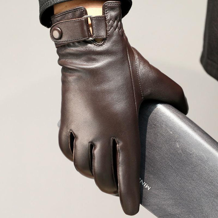 Close-up of a hand wearing dark brown leather gloves holding a sleek black wallet