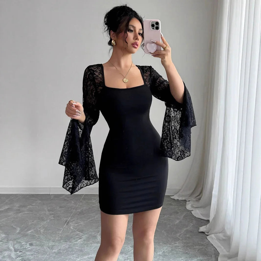 Woman taking mirror selfie wearing black bodycon dress with lace bell sleeves in minimalist room