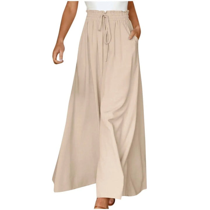 Woman wearing beige wide-leg pants with drawstring waist and pockets, styled with white top