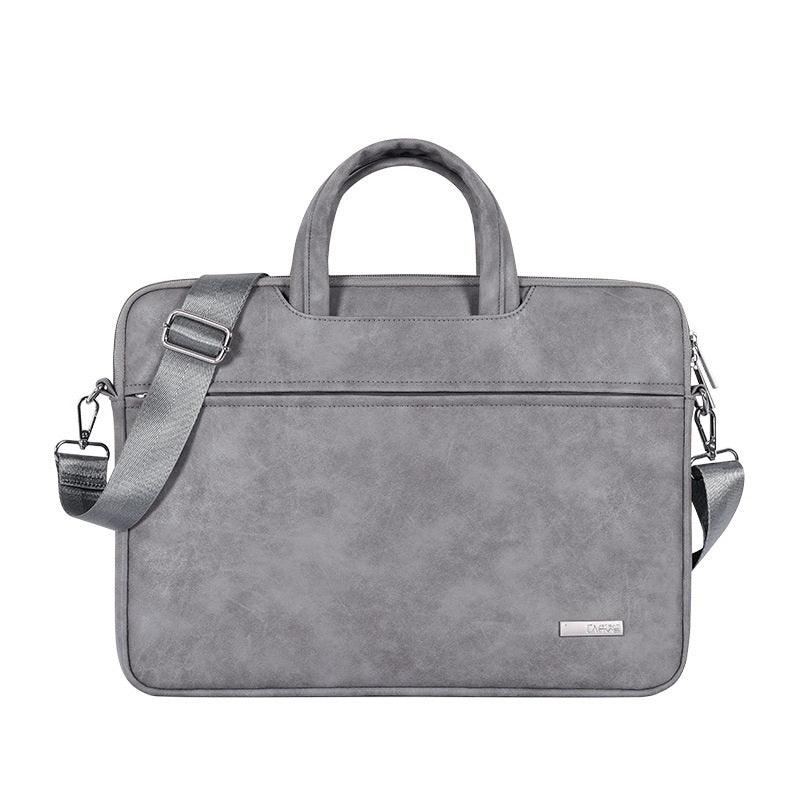 gray leather laptop bag with handles and detachable shoulder strap on white background