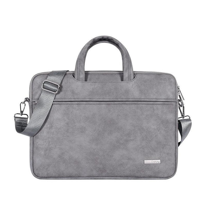 gray leather laptop bag with handles and detachable shoulder strap on white background