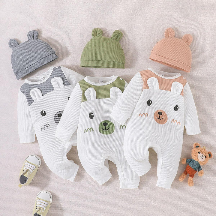 Set of three baby waffle-knit bear-themed rompers in gray, green, and peach with matching ear hats