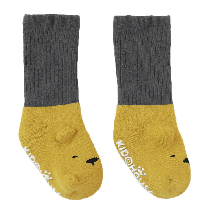 Gray and yellow toddler socks with bear face design and Kidolious brand name on soles