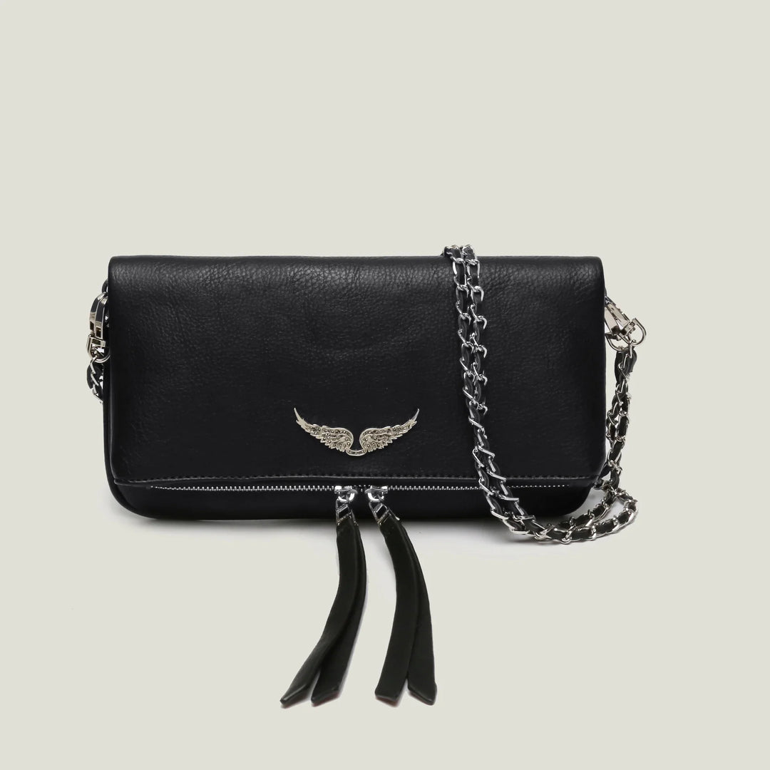 Black leather crossbody bag with silver wing emblem and chain strap on light background