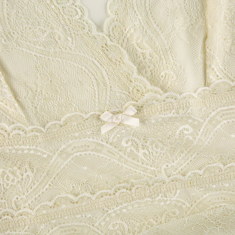 Close-up of cream lace lingerie with intricate floral patterns and a small satin bow detail