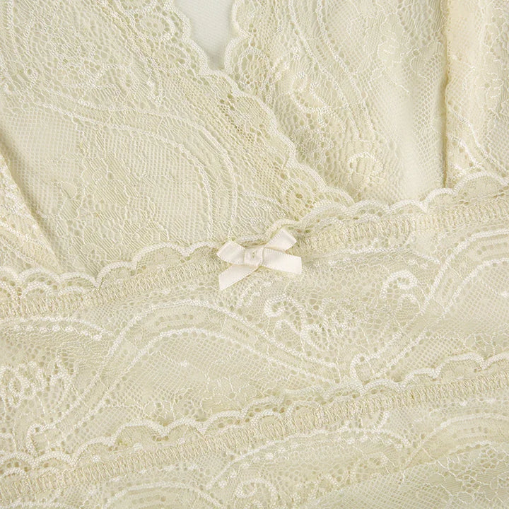 Close-up of cream lace lingerie with intricate floral patterns and a small satin bow detail