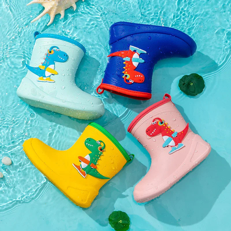 Colorful kids waterproof rain boots with dinosaur ice skating design floating in water with seashell and leaves