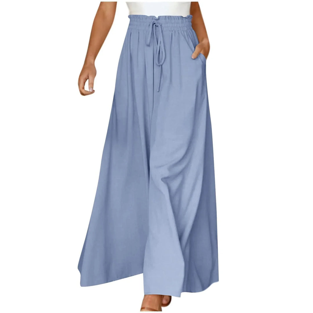 Woman wearing light blue wide-leg drawstring pants with high waist and pockets