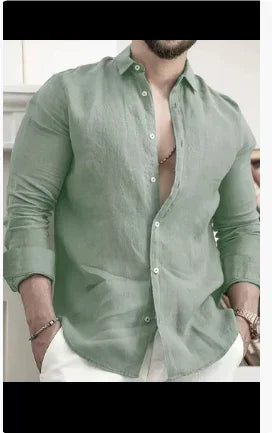 Man wearing light green unbuttoned long sleeve linen shirt with white pants indoors