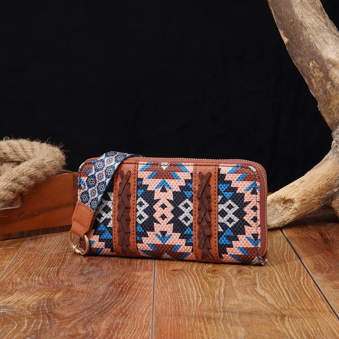 Colorful woven wallet with geometric pattern and braided leather accents on wooden surface