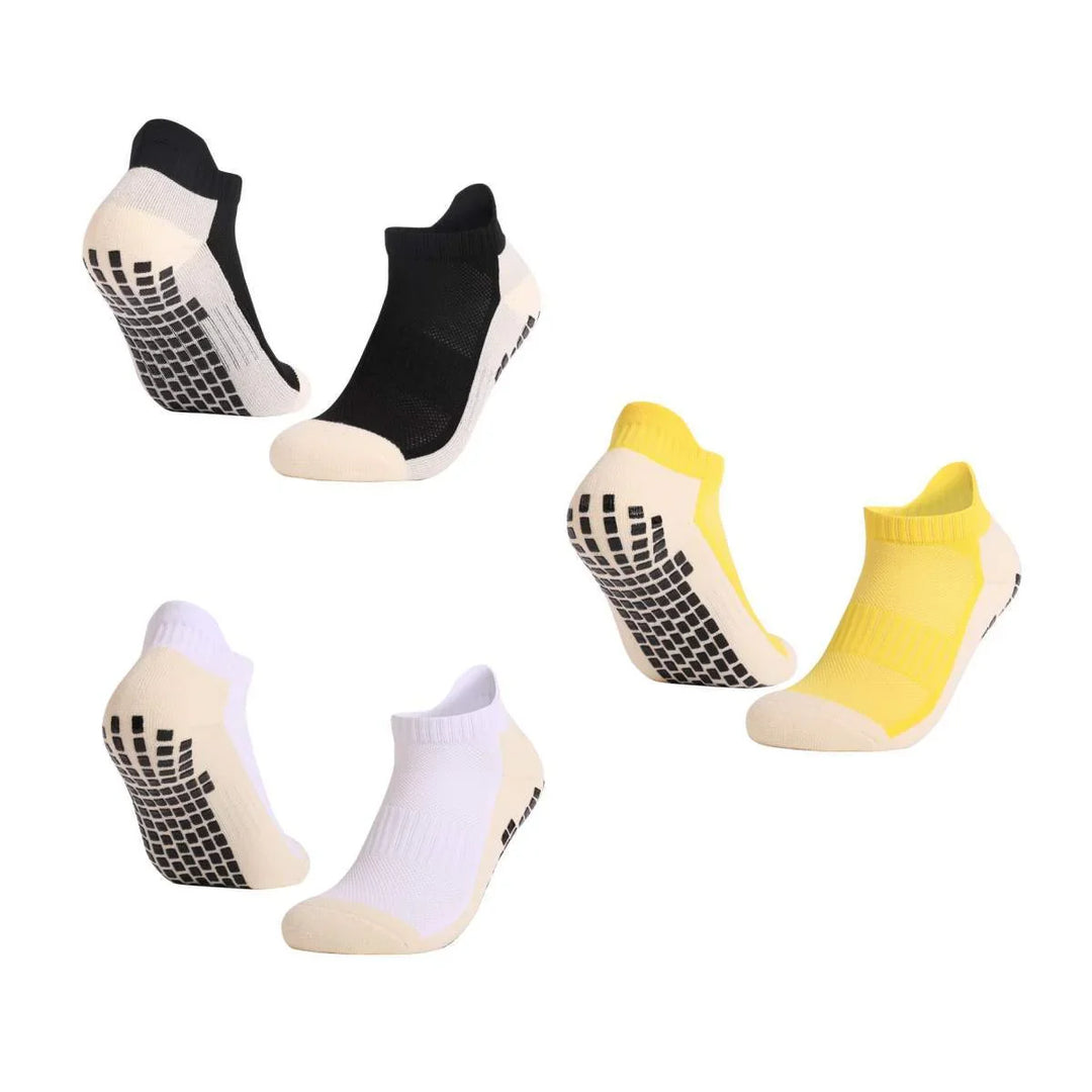 Set of non-slip ankle socks in black, white, and yellow with grip soles on white background