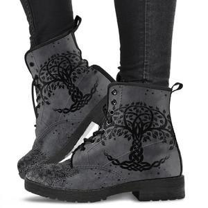 Gray suede ankle boots with black tree of life design worn with black pants