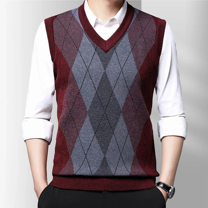 Men's sleeveless V-neck argyle sweater vest in burgundy, gray, and black over white shirt