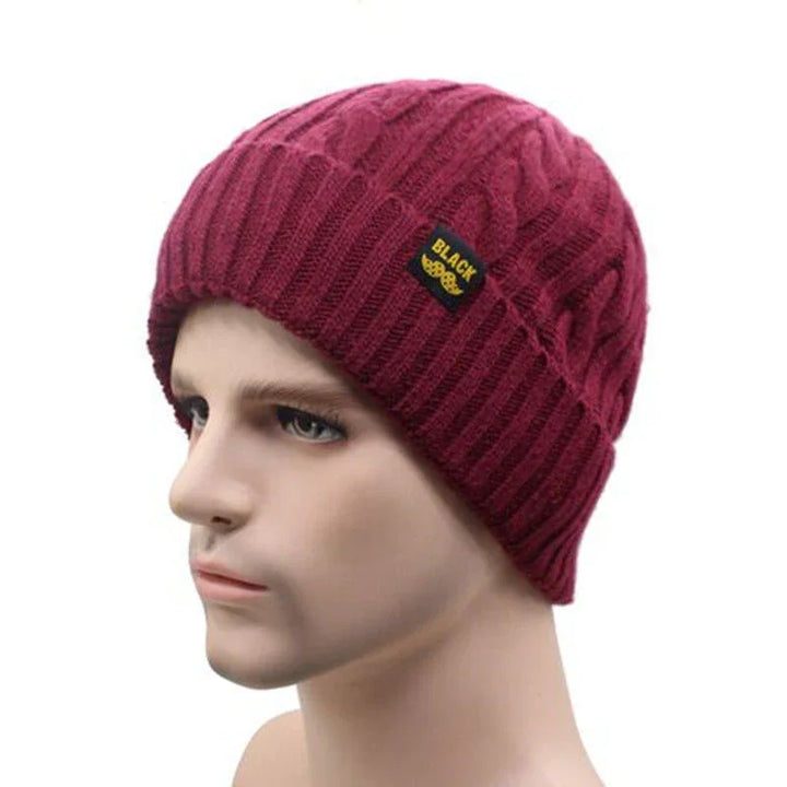 Maroon cable knit beanie hat with black label on male mannequin head