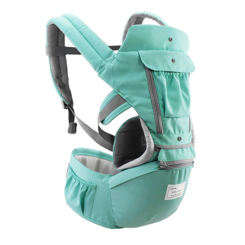 Mint green ergonomic baby carrier with padded shoulder straps, waist support, and multiple pockets