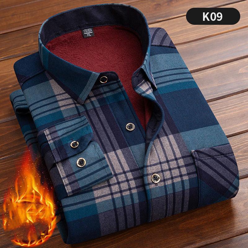 Folded blue and navy plaid flannel shirt with soft red lining on wooden surface, warm fabric icon