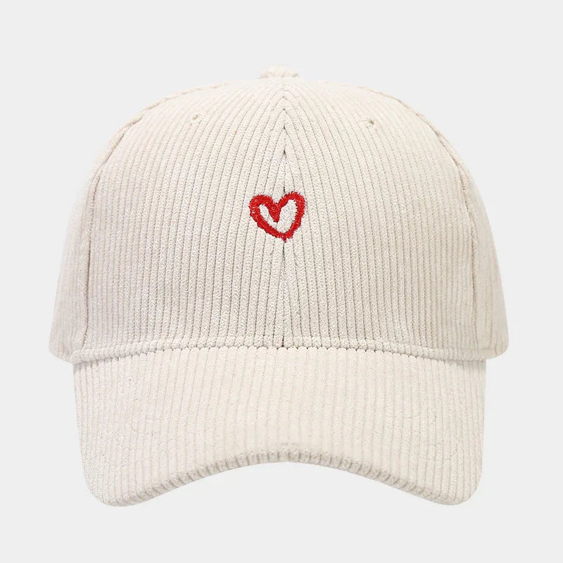 Beige corduroy baseball cap with small red embroidered heart on front