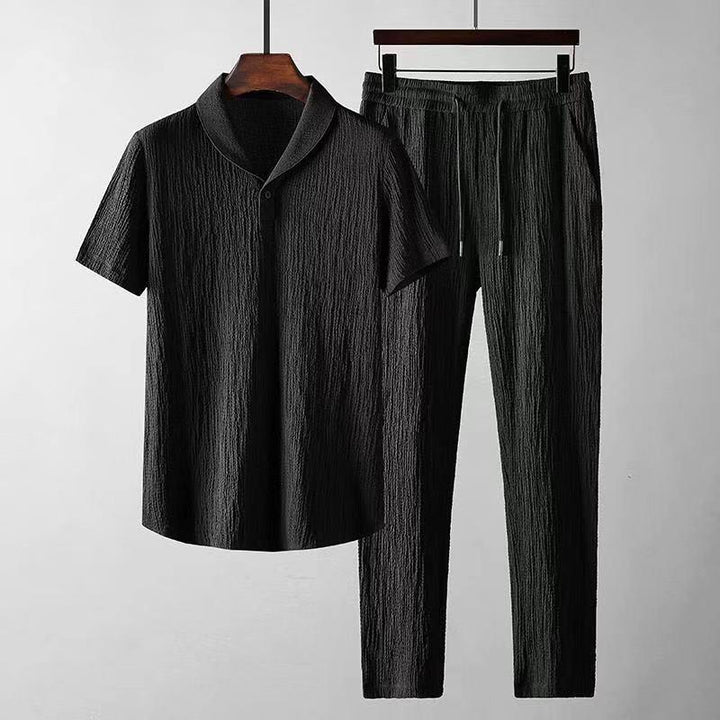 Black textured short sleeve shirt and matching elastic waist pants set on hangers