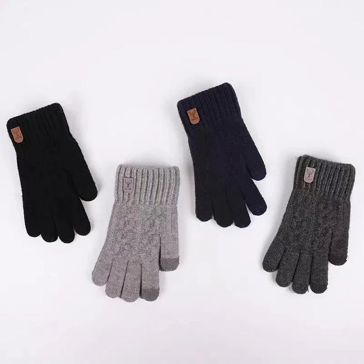 Four pairs of knitted winter gloves in black, navy, light gray, and dark gray with ribbed cuffs and small leather tags