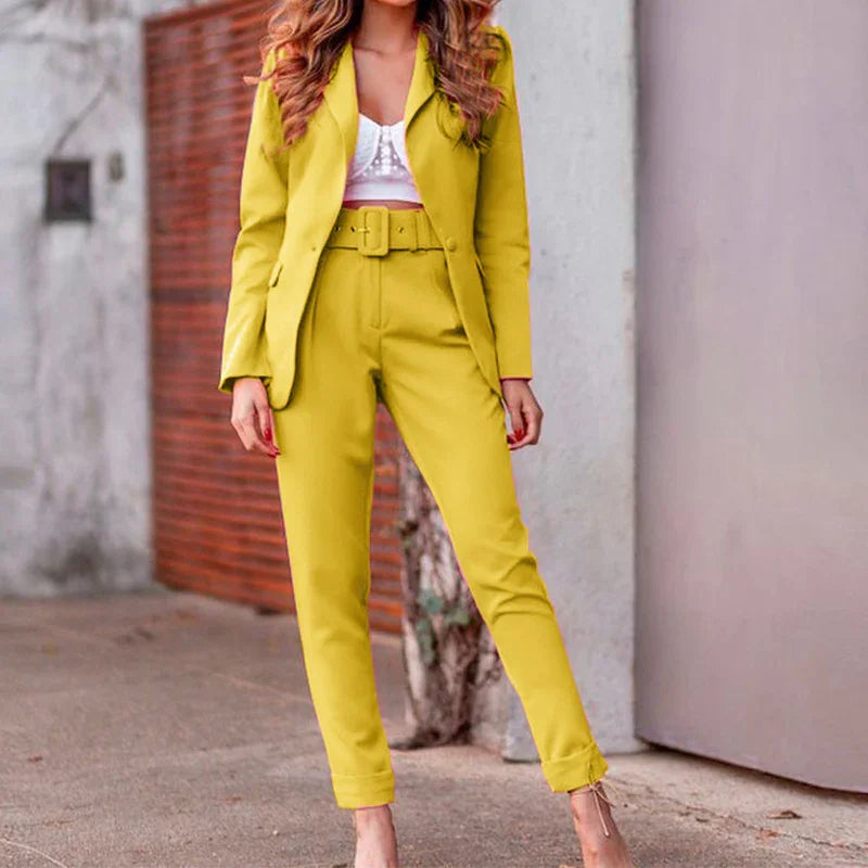 Woman wearing a yellow belted suit with cropped pants and a white crop top outdoors