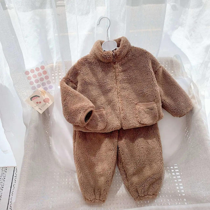Brown fluffy zip-up jacket and pants toddler winter outfit displayed on white chair