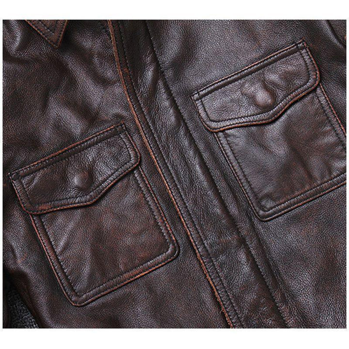 Close-up of dark brown leather jacket with two flap pockets and detailed stitching