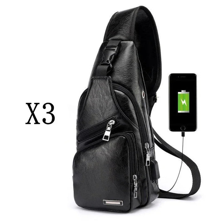 Black leather crossbody sling bag with multiple zippered pockets and phone charging feature