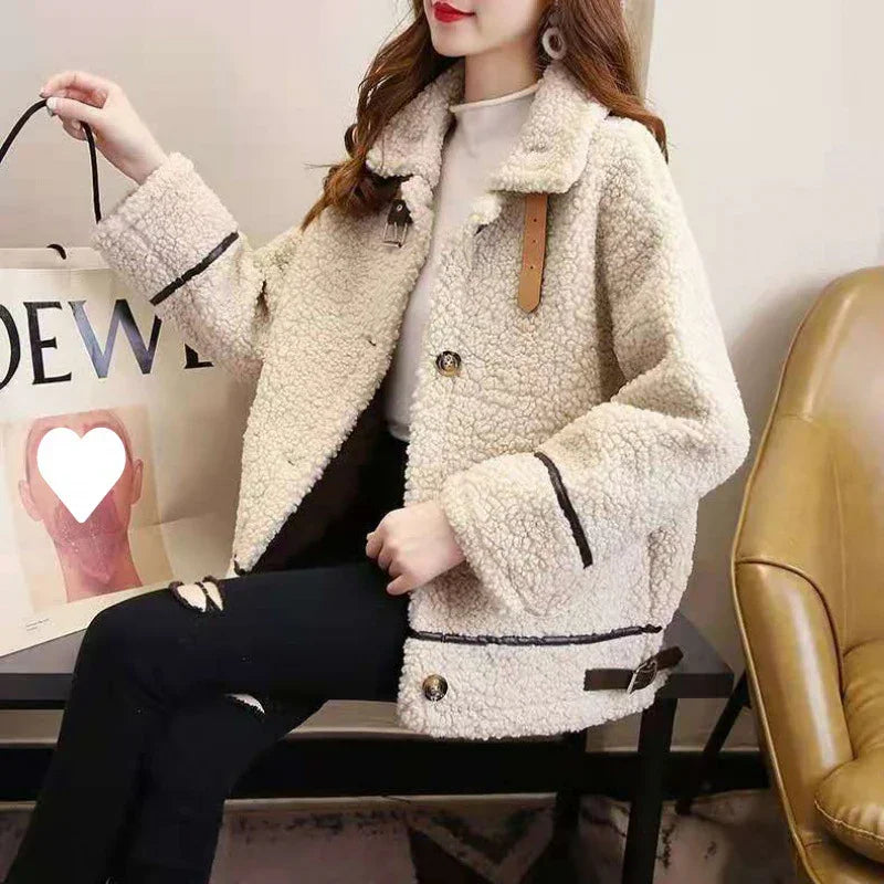 Woman wearing beige sherpa fleece jacket with button and buckle details, holding a shopping bag