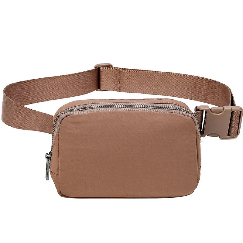 Brown nylon waist bag with zipper and adjustable strap on white background