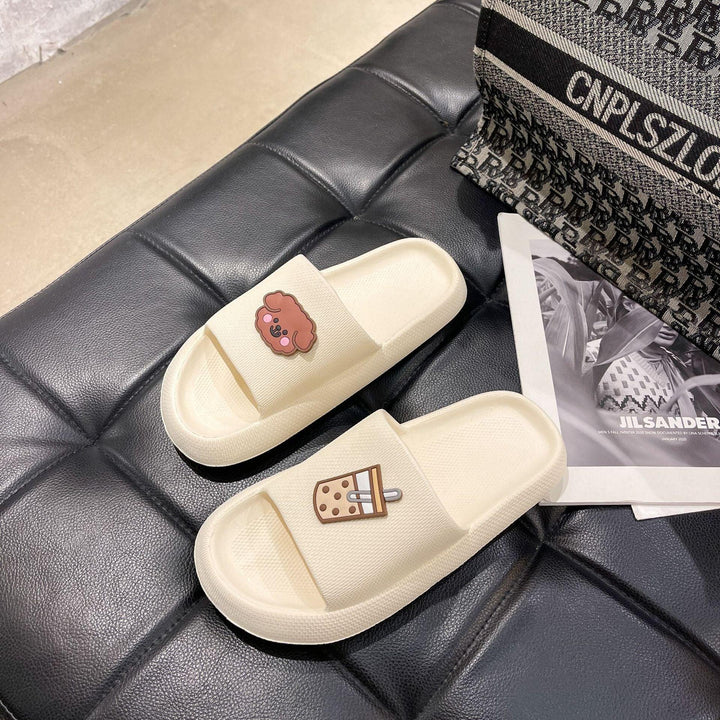 Off-white casual slide sandals with cute cartoon dog and bubble tea charms on black tufted leather surface