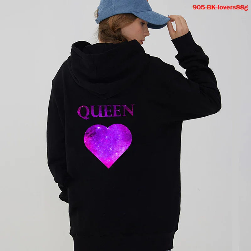 Woman wearing black hoodie with purple galaxy heart and QUEEN text on back, blue cap