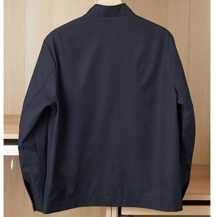 Navy blue casual jacket hanging on a wooden shelf background