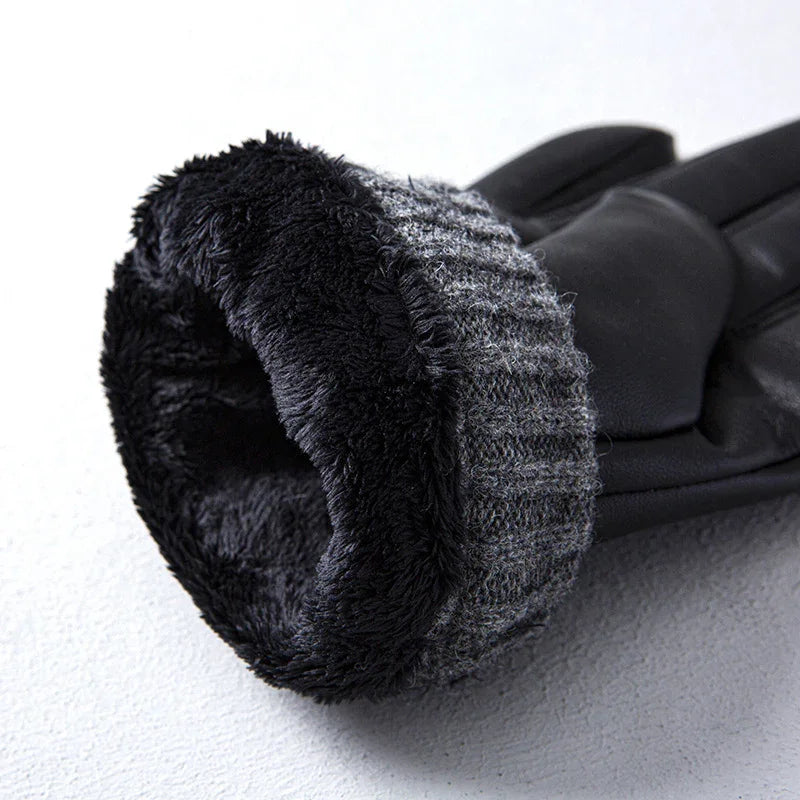Close-up of black winter glove with soft fleece lining and knitted cuff on white surface