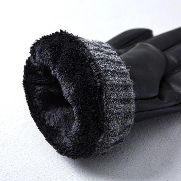 Close-up of black winter glove with soft fleece lining and knitted cuff on white surface