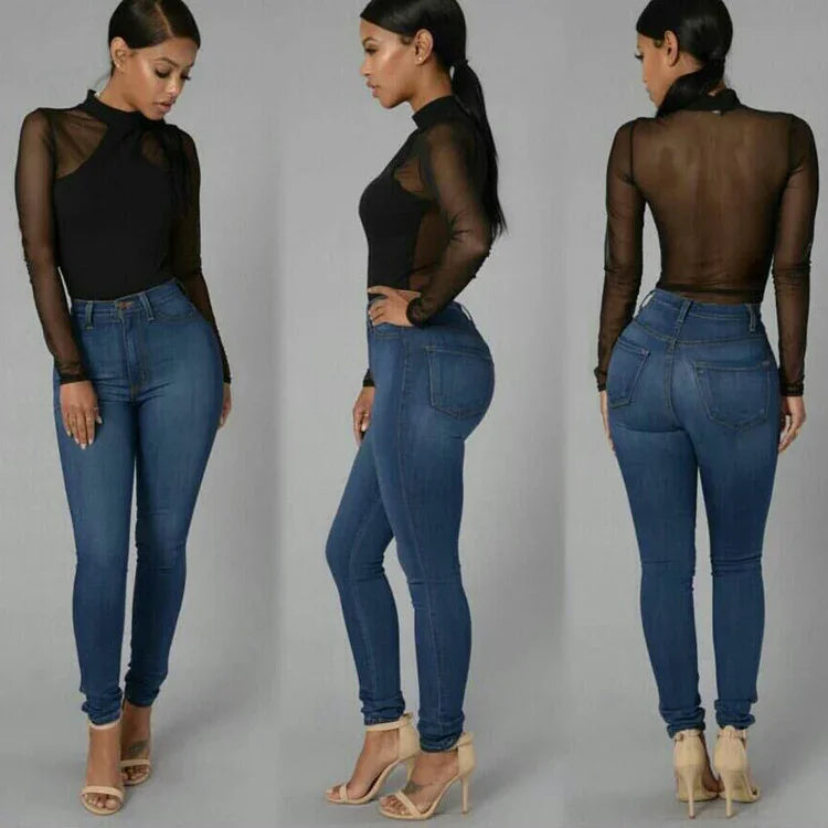Woman modeling black sheer long-sleeve top and high-waisted blue skinny jeans with nude heels