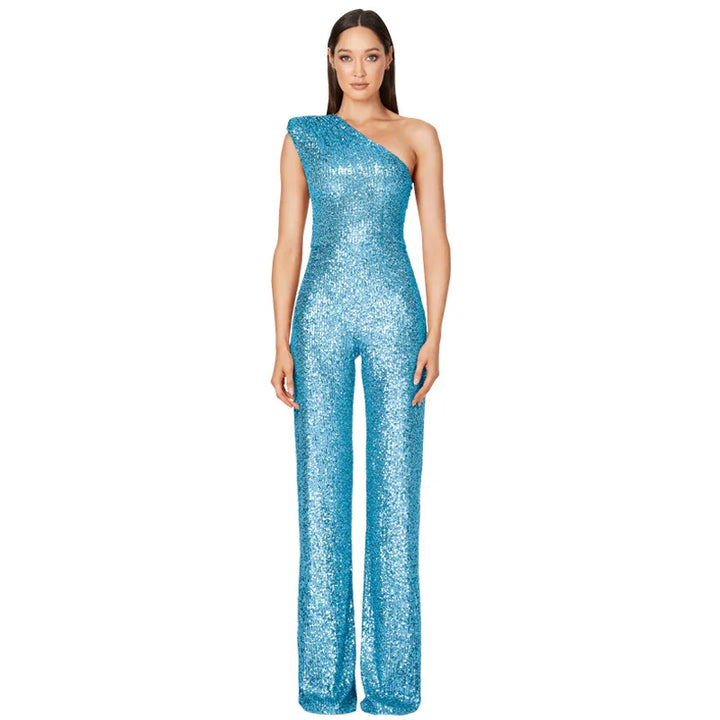 Woman wearing a sparkling blue one-shoulder sequin jumpsuit on white background