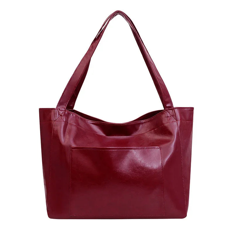 Stylish maroon leather tote bag with long handles and a front pocket