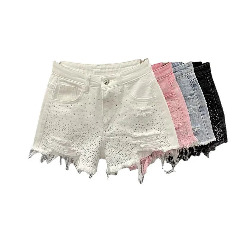 Set of distressed denim shorts in white, pink, gray, and black with stud detailing and frayed hems