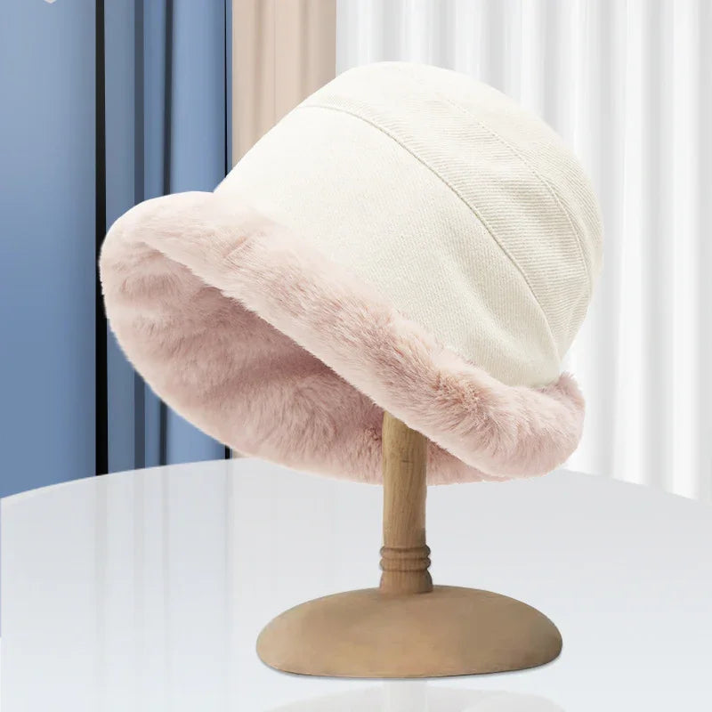 Cozy beige bucket hat with soft pink faux fur lining displayed on wooden stand