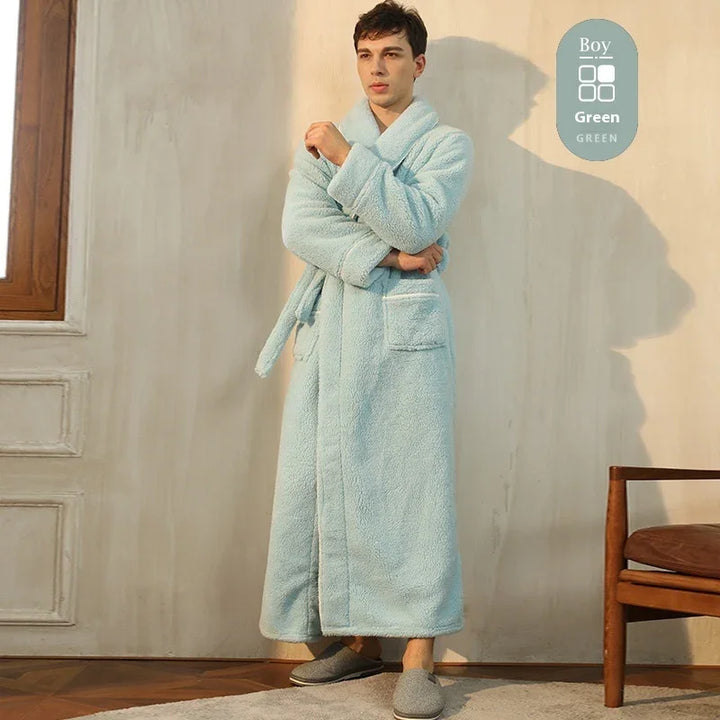 Man wearing light blue cozy bathrobe standing indoors near wooden chair and window