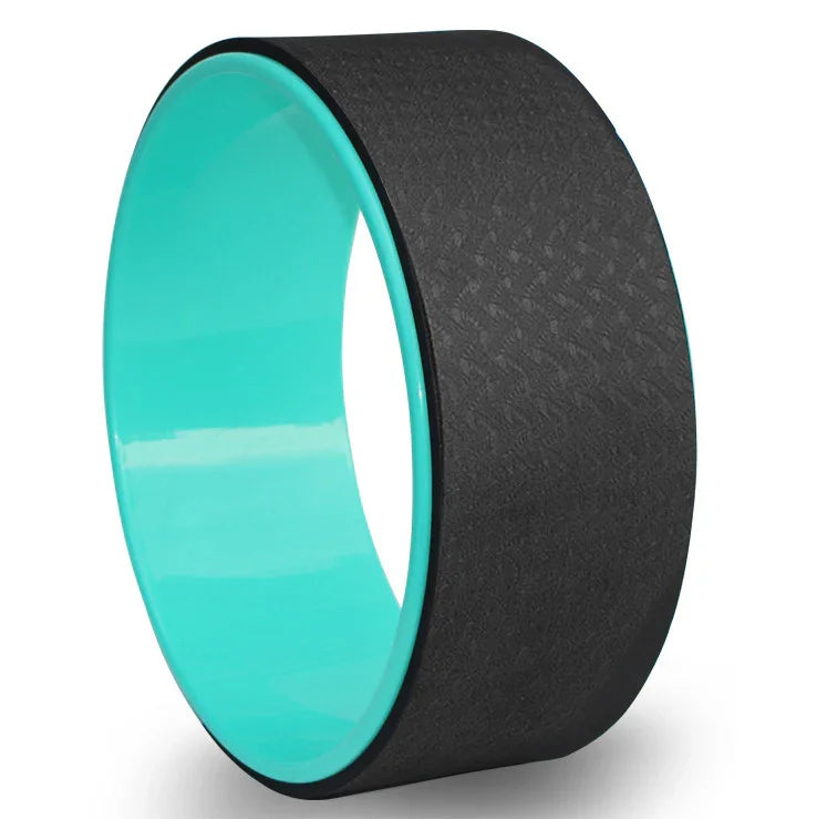 Black foam yoga wheel with textured surface and turquoise inner ring