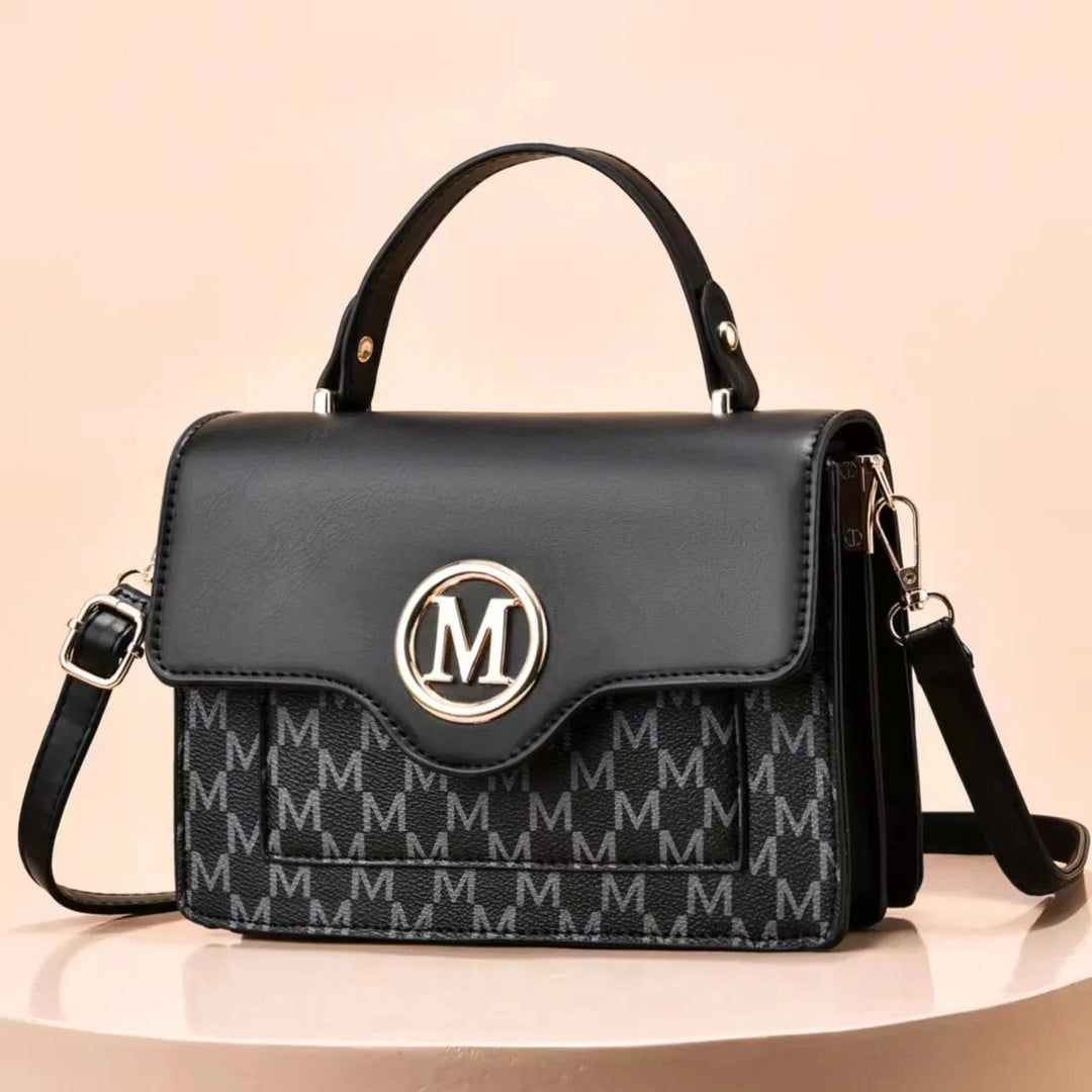 Black leather handbag with top handle and detachable shoulder strap, patterned with repeated M letters