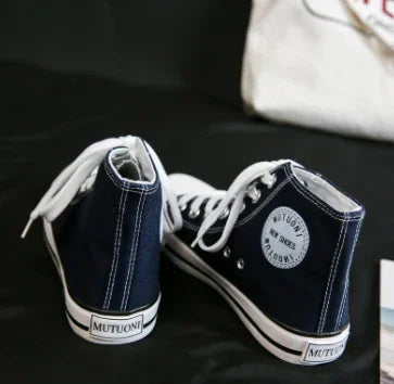 pair of navy blue high-top sneakers with white laces and MUTUONI logo on heel