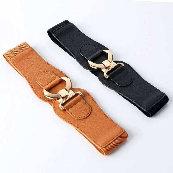 Two wide women's stretch belts with gold oval buckles, one in tan and one in black leather on white background