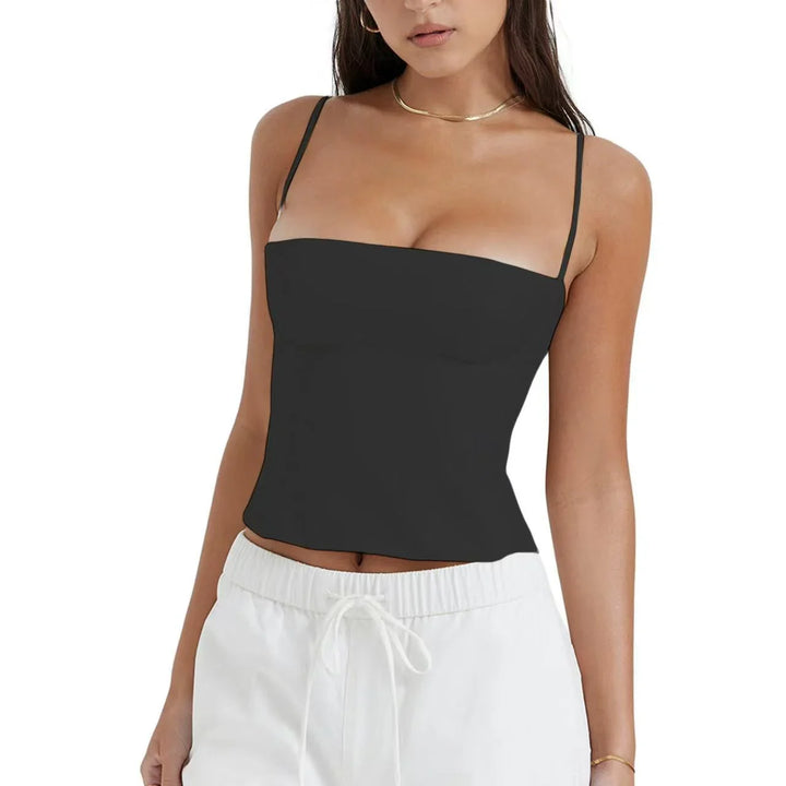Woman wearing black spaghetti strap cropped top and white drawstring pants on white background