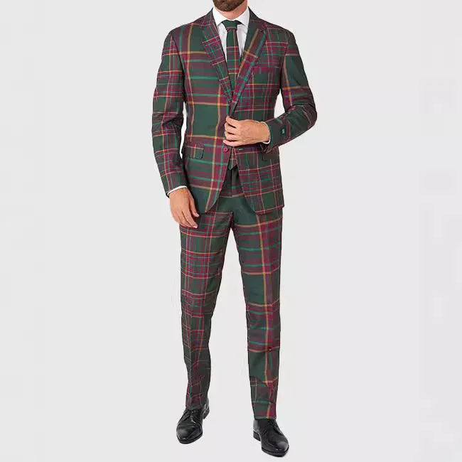 Man wearing green and red plaid suit with black tie and dress shoes on plain white background