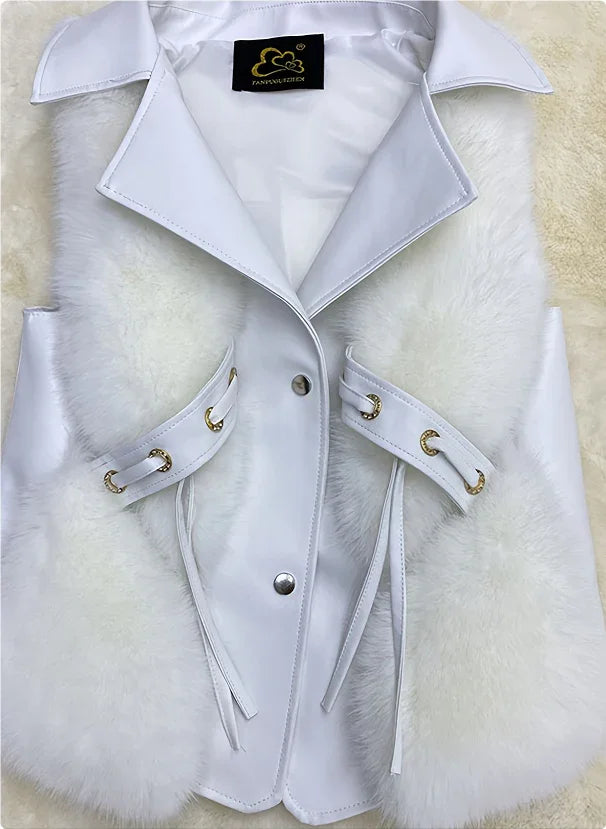 White faux fur vest with leather trim, collar, and gold grommet accents on a soft background